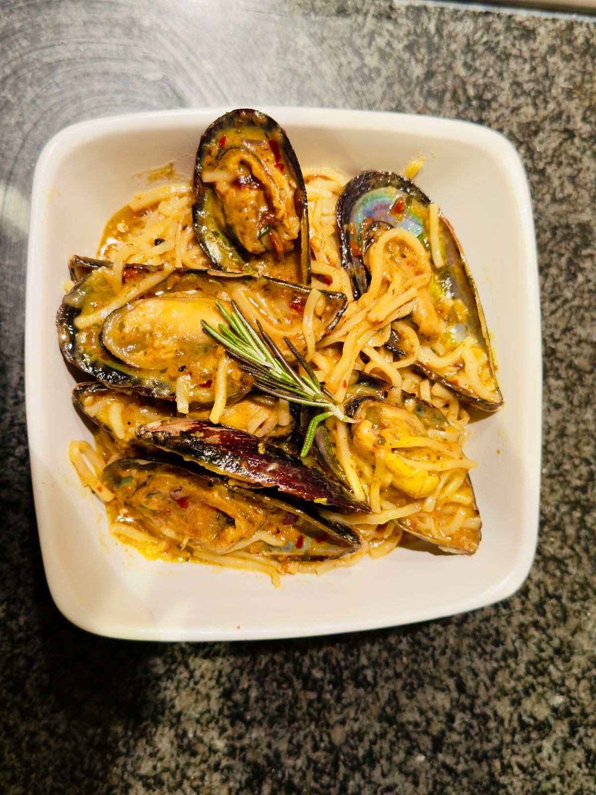 Creamy garlic butter mussels in a rich sauce with onions and herbs.